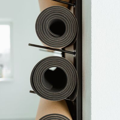 Yoga mat rolled out in a calm, minimalist space.